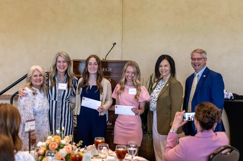 Two girls accepting awards with group
